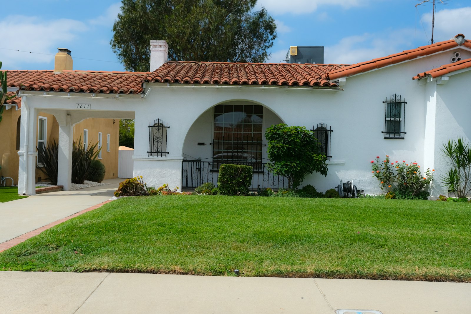 Stucco home with red tile roof and a tidy desert front yard, common in Phoenix.